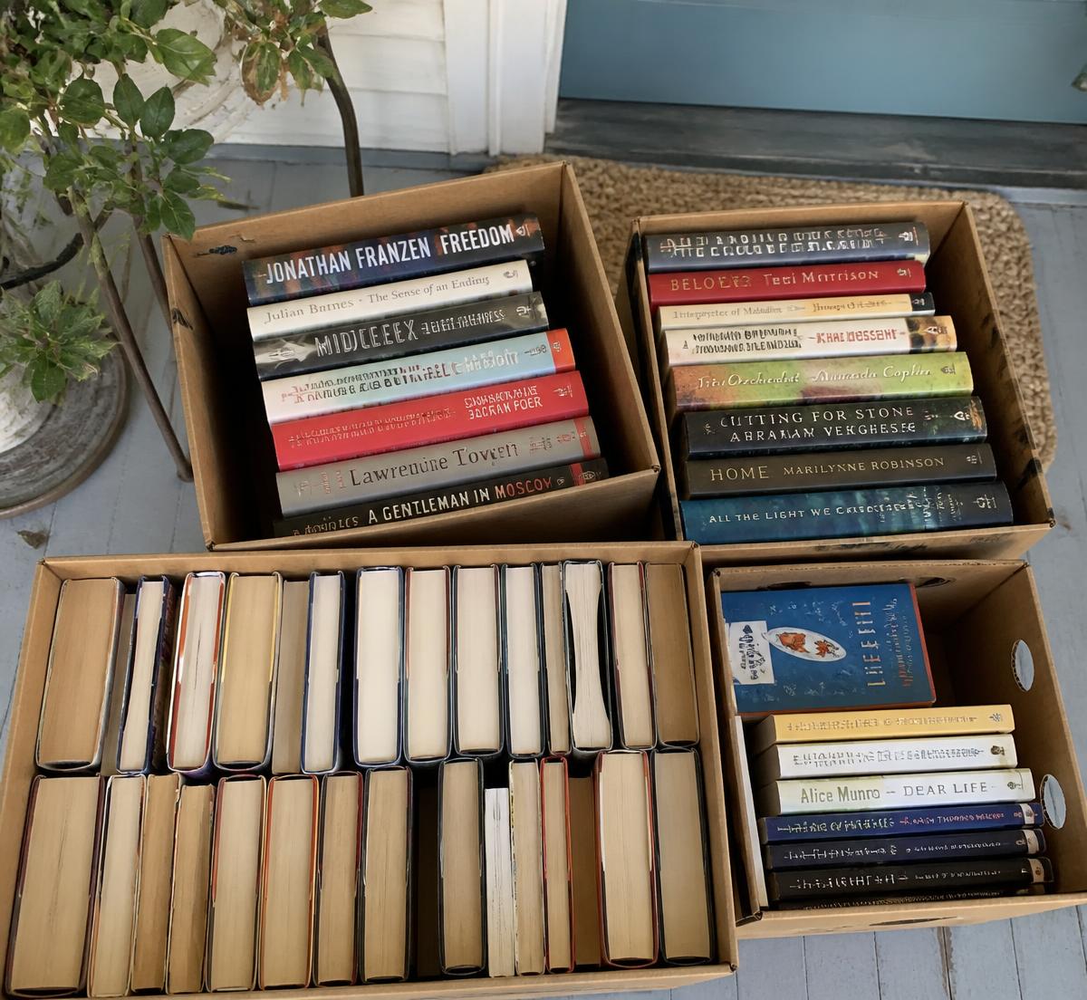 Boxes of donated books ready for a free pickup on a Cleveland home's porch